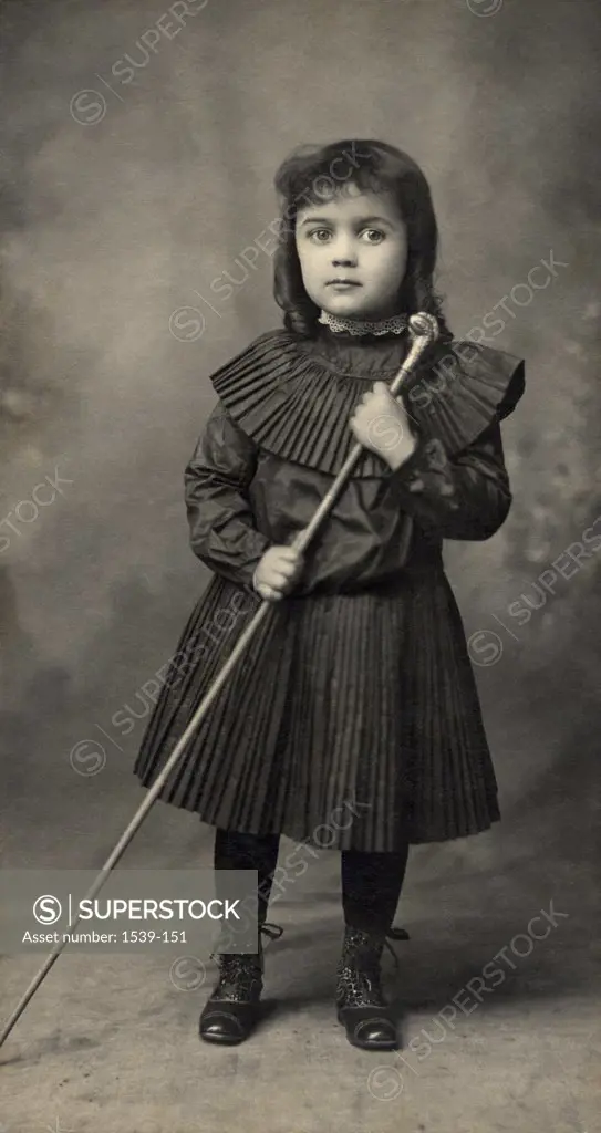 Portrait of a girl holding a cane, c. 1895