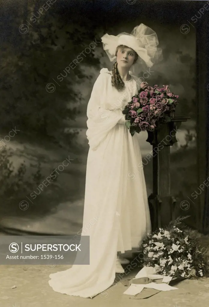 Portrait of a bride holding a bouquet of flowers, c. 1918