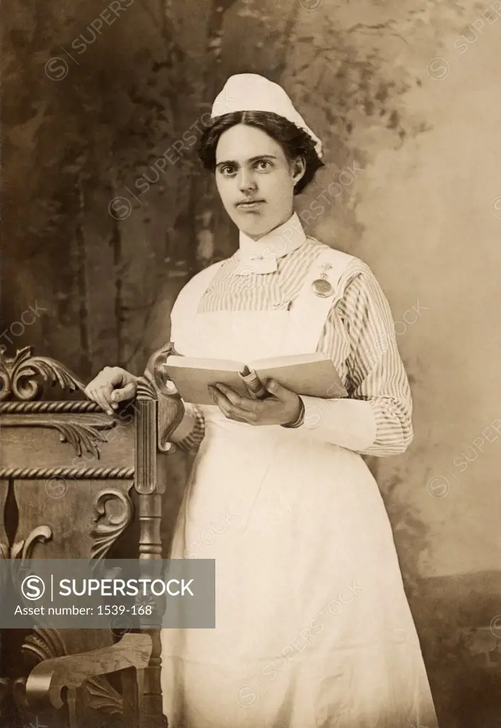 Portrait of a female nurse holding a book, 1908