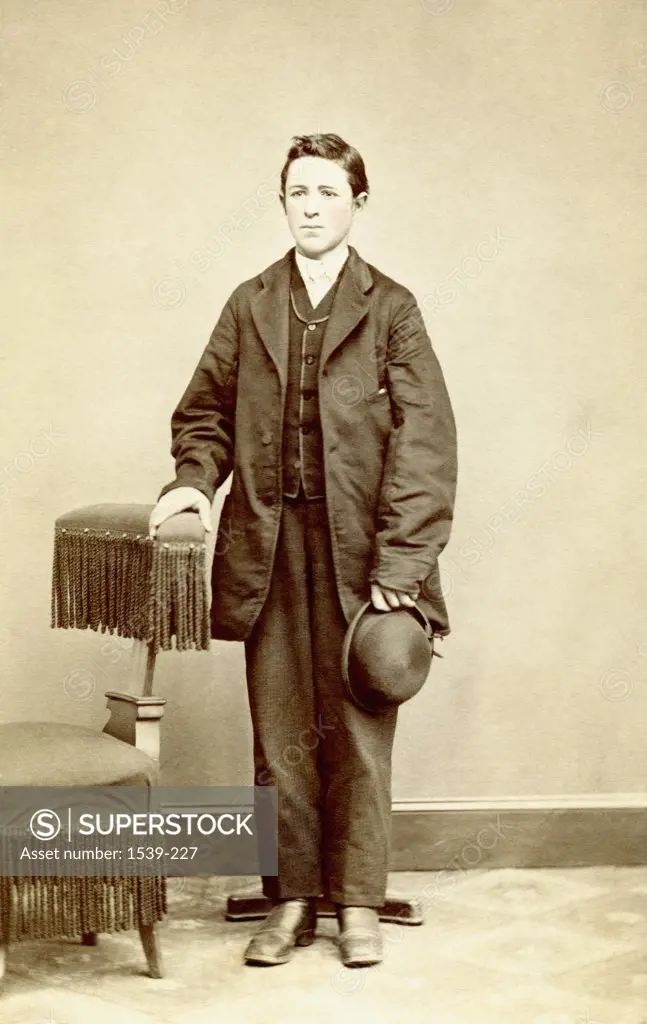 Teenage boy standing near a chair, Pennsylvania, USA, 1860