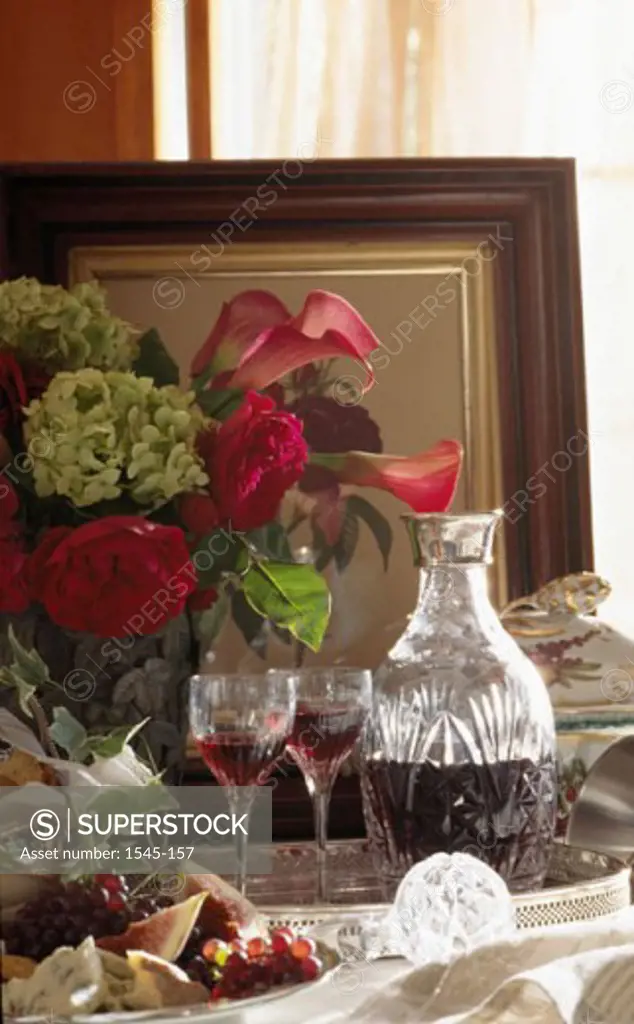 Wine bottle with two wineglasses and a vase