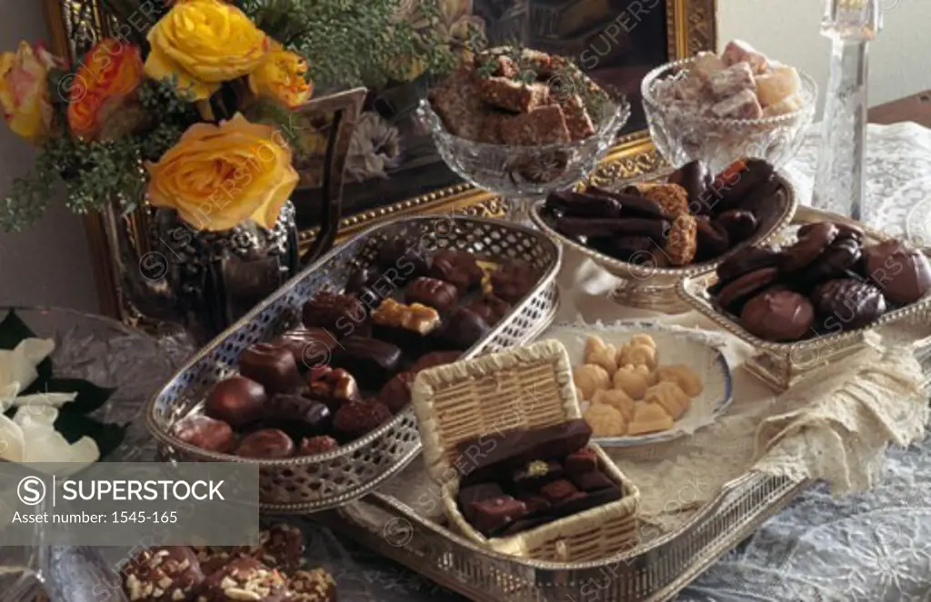 Close-up of chocolate candy with a serving tray and baskets on a table