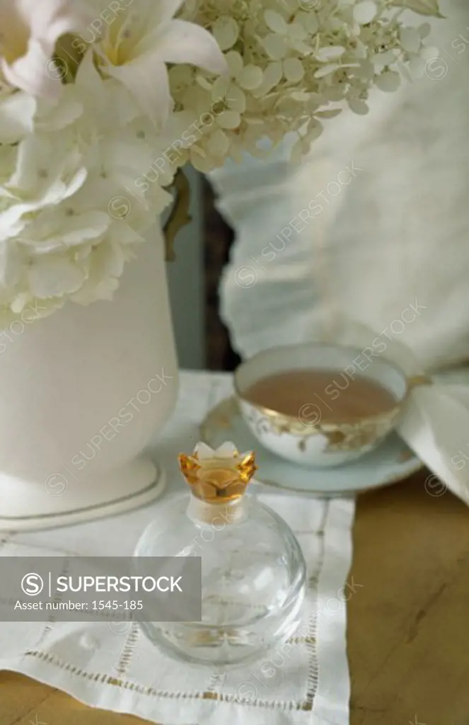 Close-up of a flower vase with a tea cup