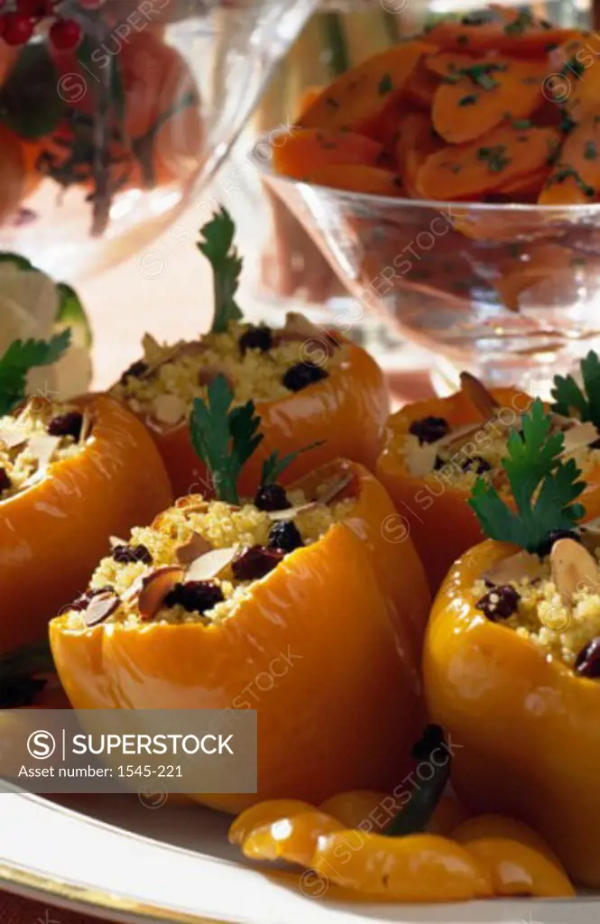 Close-up of stuffed yellow bell peppers on a platter
