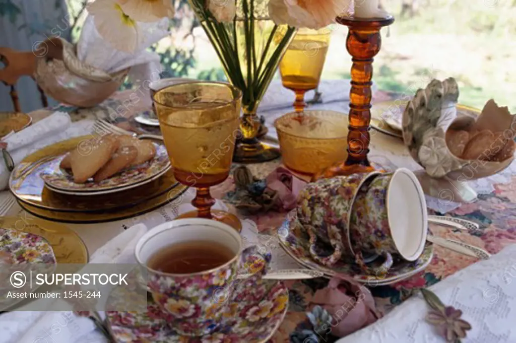 Close-up of a cup of herbal tea with stem glasses on a table