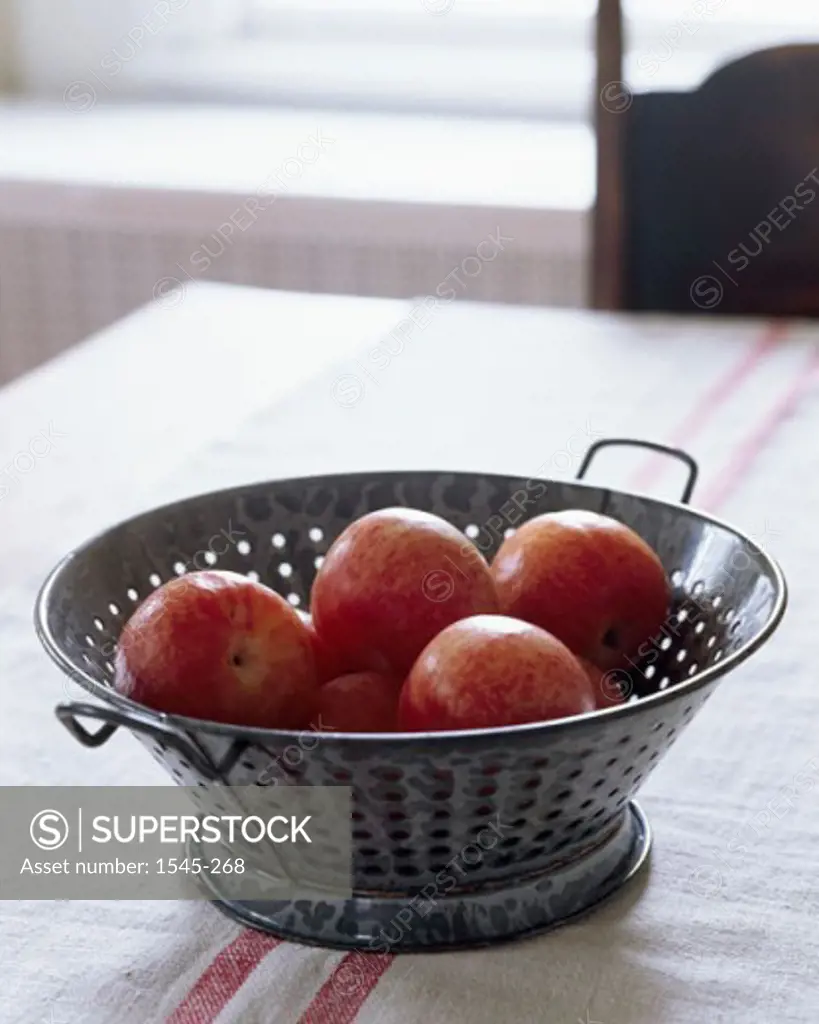 Close-up of apples in a colander on a table