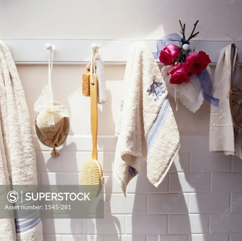 Close-up of towels with a brush hanging in the bathroom