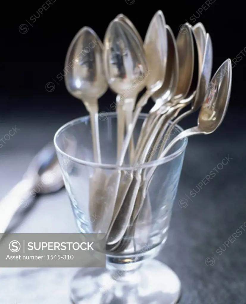 Close-up of spoons in a stem glass