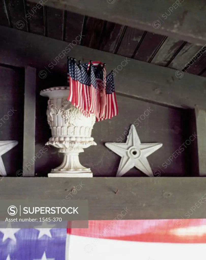 Close-up of flags in a decorative urn with a star beside it