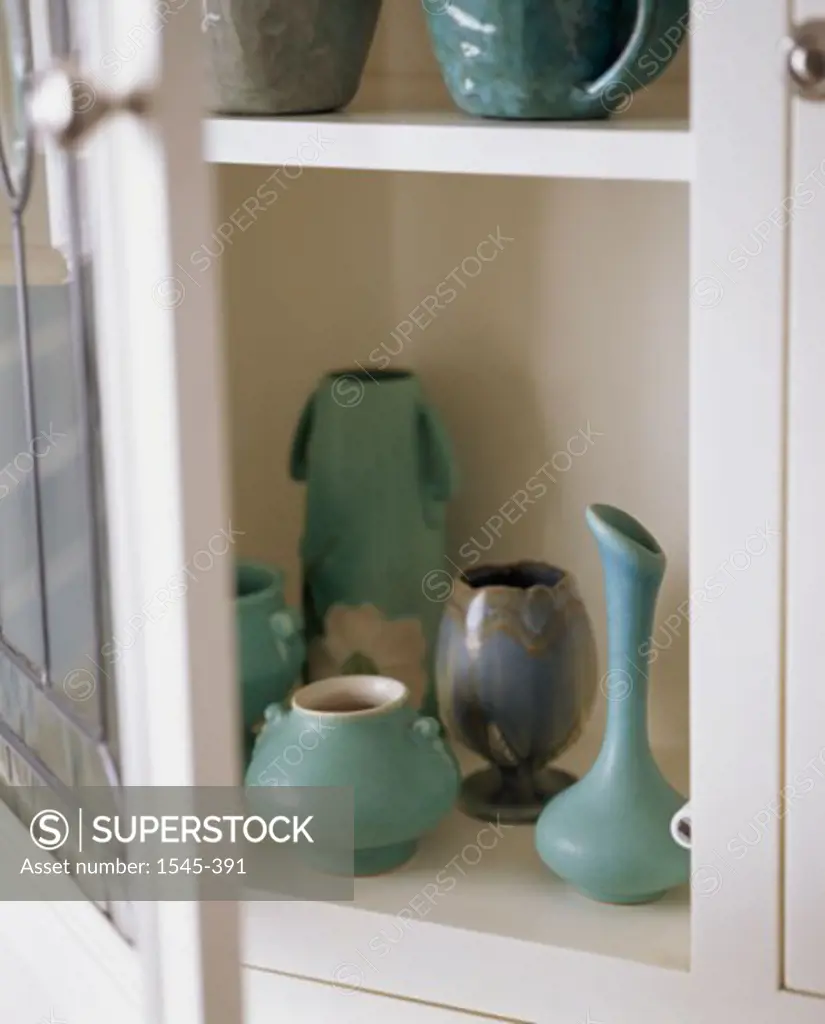 Close-up of ceramic pottery in a cabinet