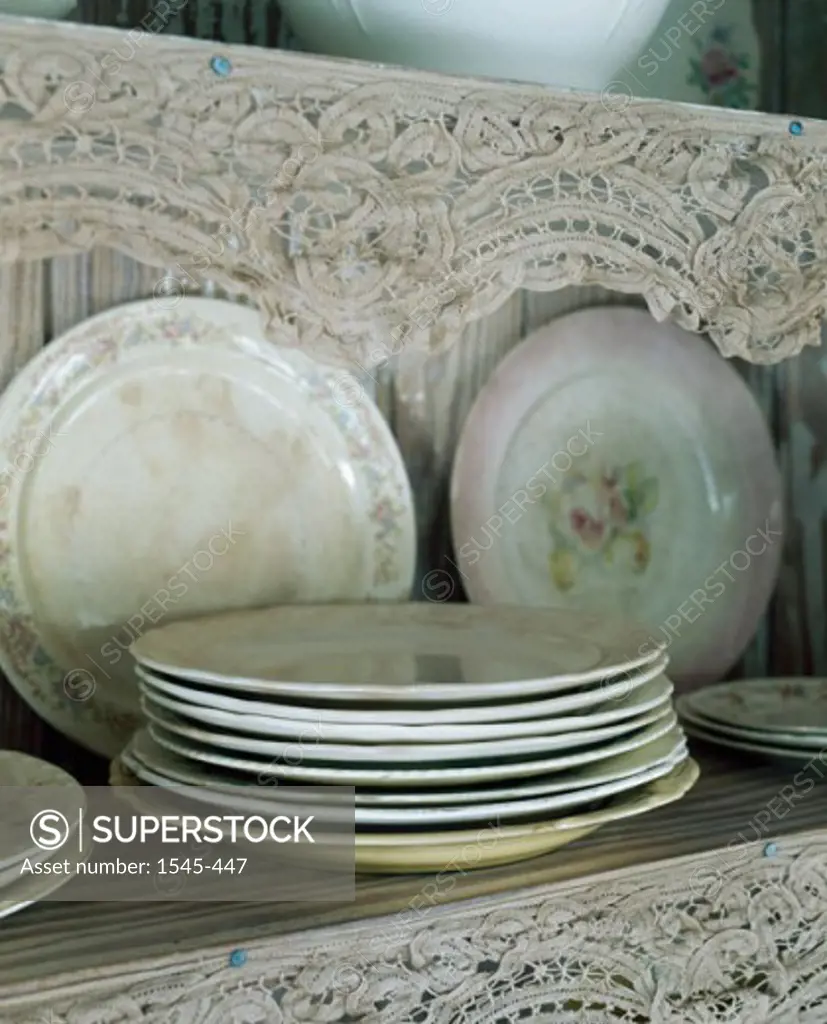 Close-up of plates on a shelf