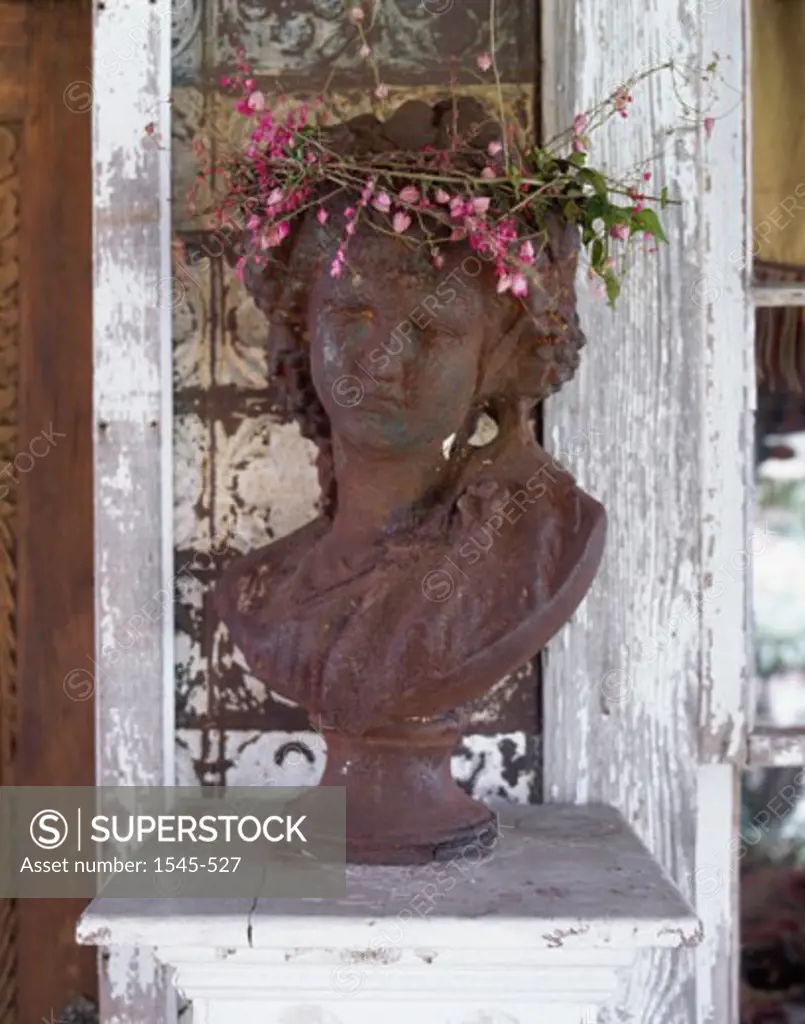 Close-up of a bust of a woman wearing flowers