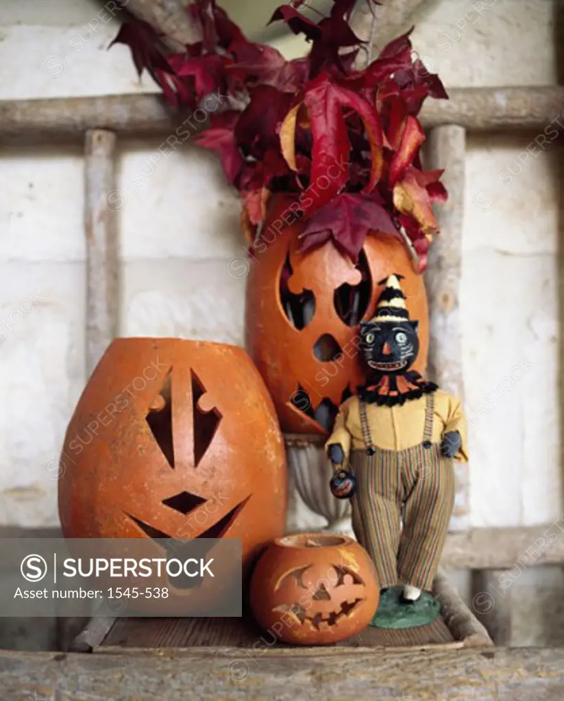 Close-up of jack o' lanterns with a figurine of a clown
