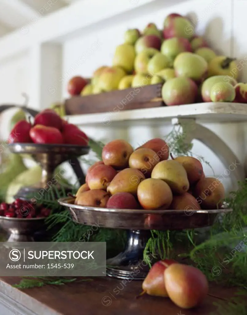 Close-up of pears and apples on a shelf