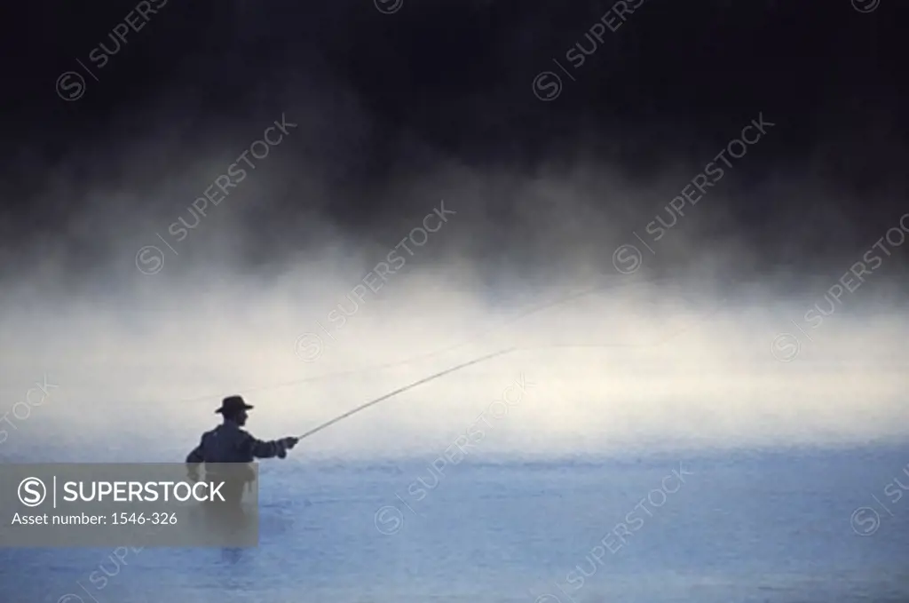 Silhouette of a fisherman fishing in a river, Stampede Reservoir, California, USA