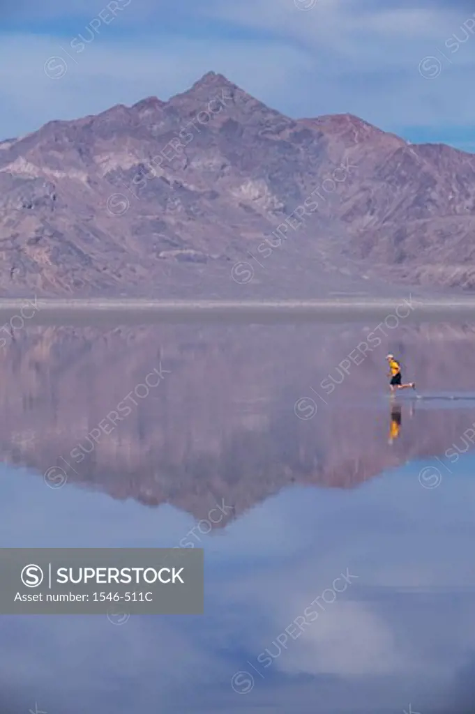 Side profile of a man running across a salt flat, Bonneville Salt Flats, Utah, USA