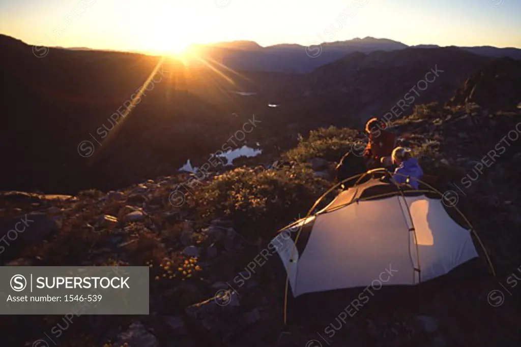 High angle view of a man and a woman sitting near a tent
