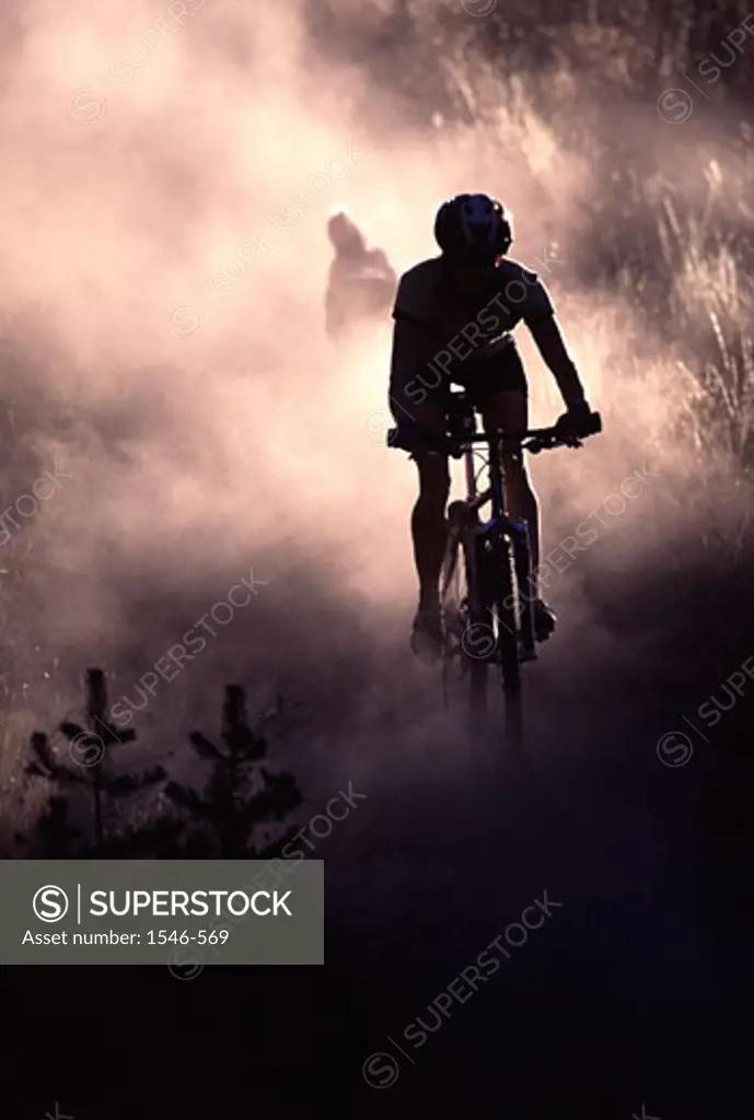 Silhouette of a person riding a mountain bike