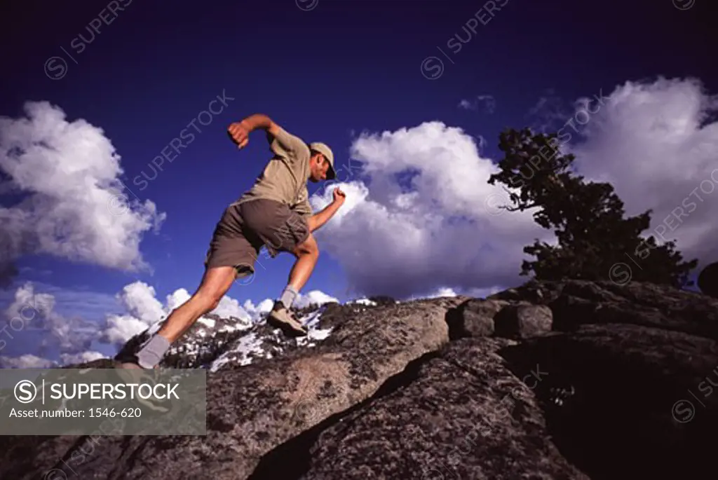 Low angle view of a man running up a hill