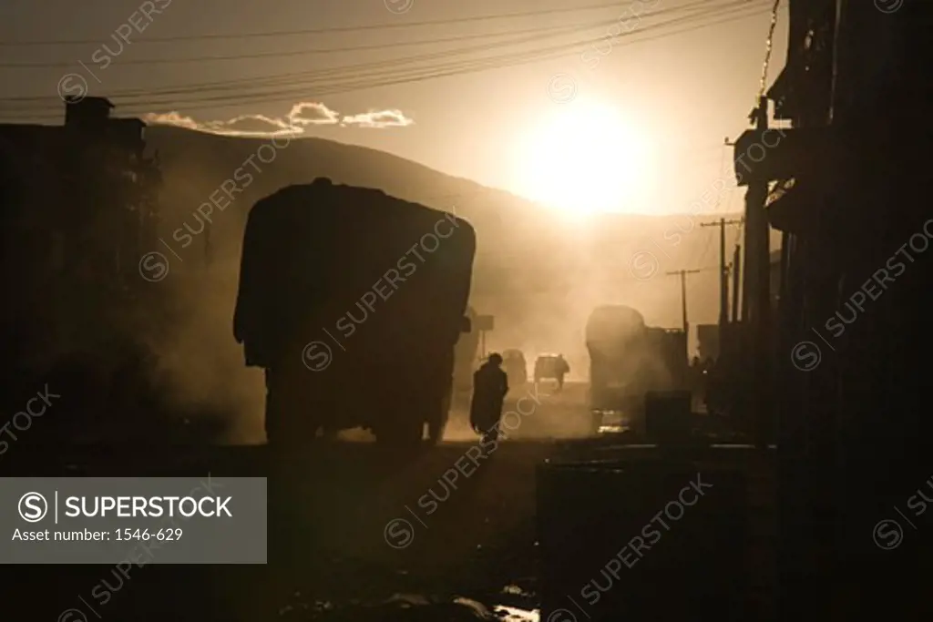 Silhouette of a person standing near a truck on the street, Tingri, Tibet, China