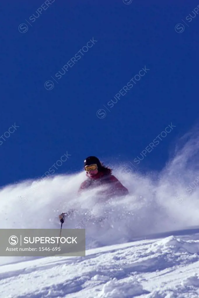 Low angle view of a woman skiing on snow