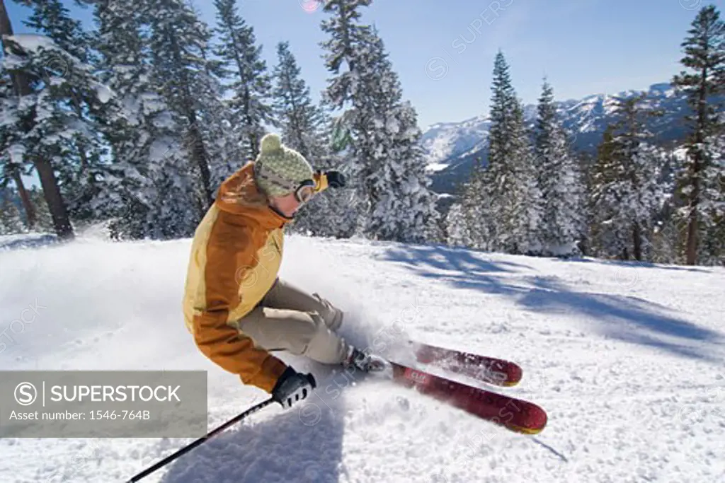 Side profile of a woman skiing on snow, Lake Tahoe, California, USA