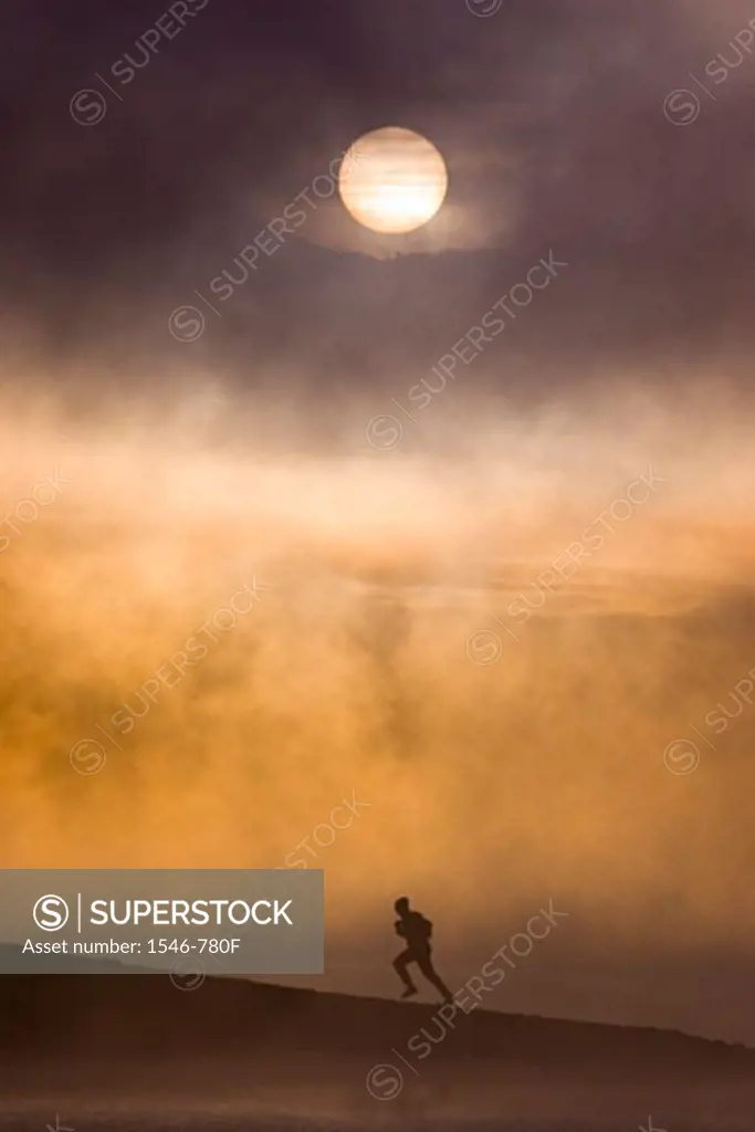 Silhouette of a man hiking near a lake, Truckee, California, USA