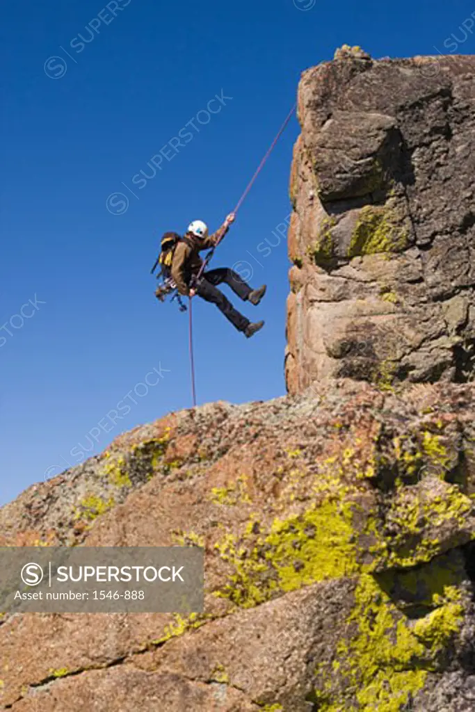 Man rappelling off a cliff, Lake Tahoe, Nevada, USA