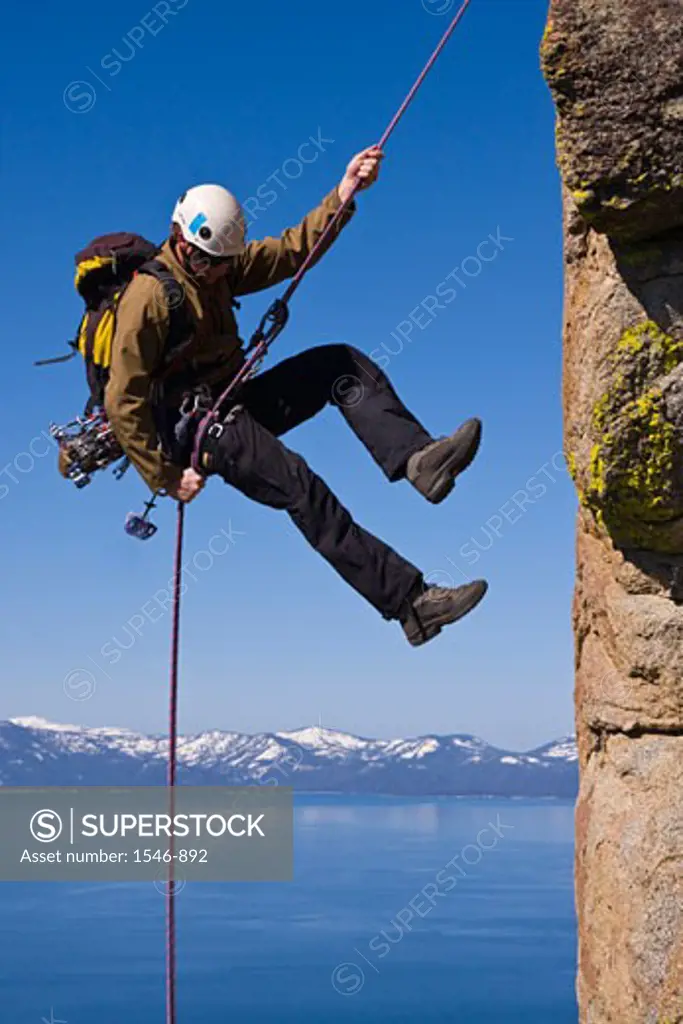 Man rappelling off a cliff, Lake Tahoe, Nevada, USA