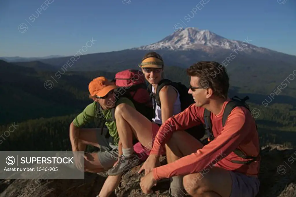 Three hikers on a mountain summit, Mt Adams, Washington State, USA