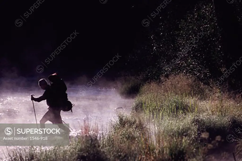 Hiker crossing a river, Truckee River, Truckee, Nevada County, California, USA