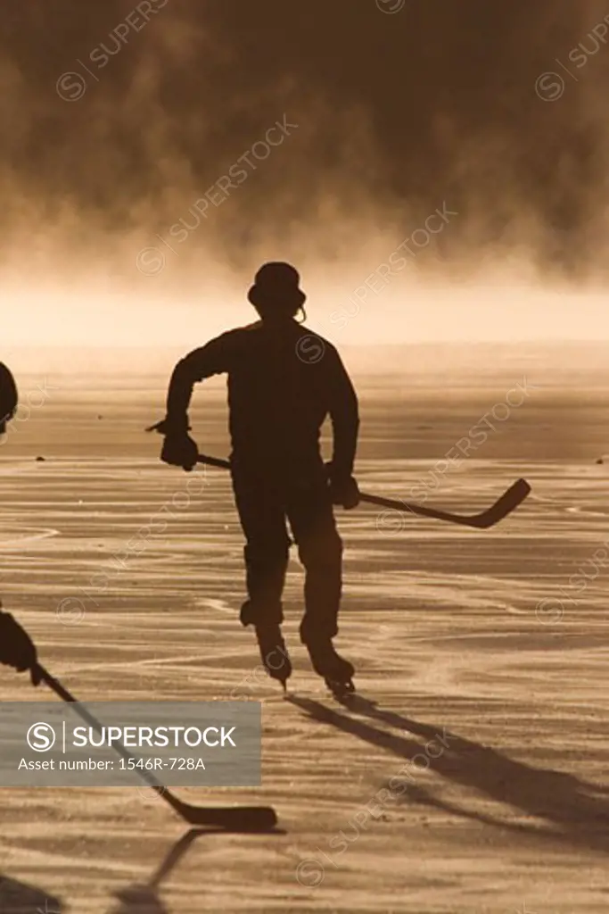 Silhouette of ice hockey players playing ice hockey