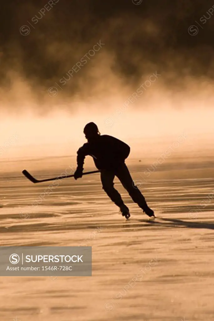 Silhouette of ice hockey player playing ice hockey
