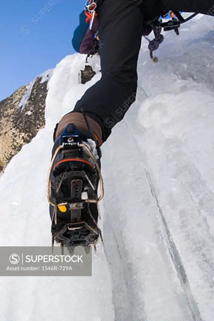 Low angle view of a person climbing on ice