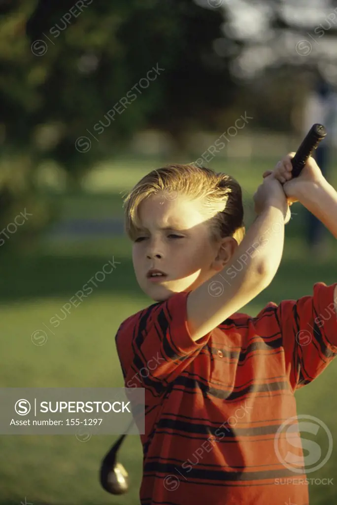 Close-up of a boy playing golf