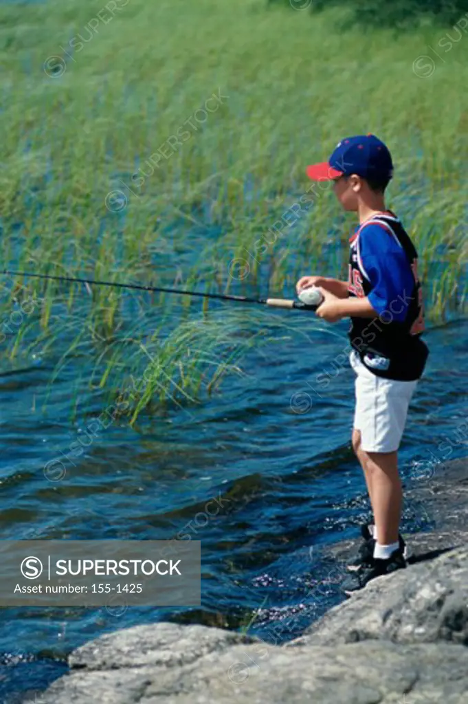 Boy fly-fishing in a lake