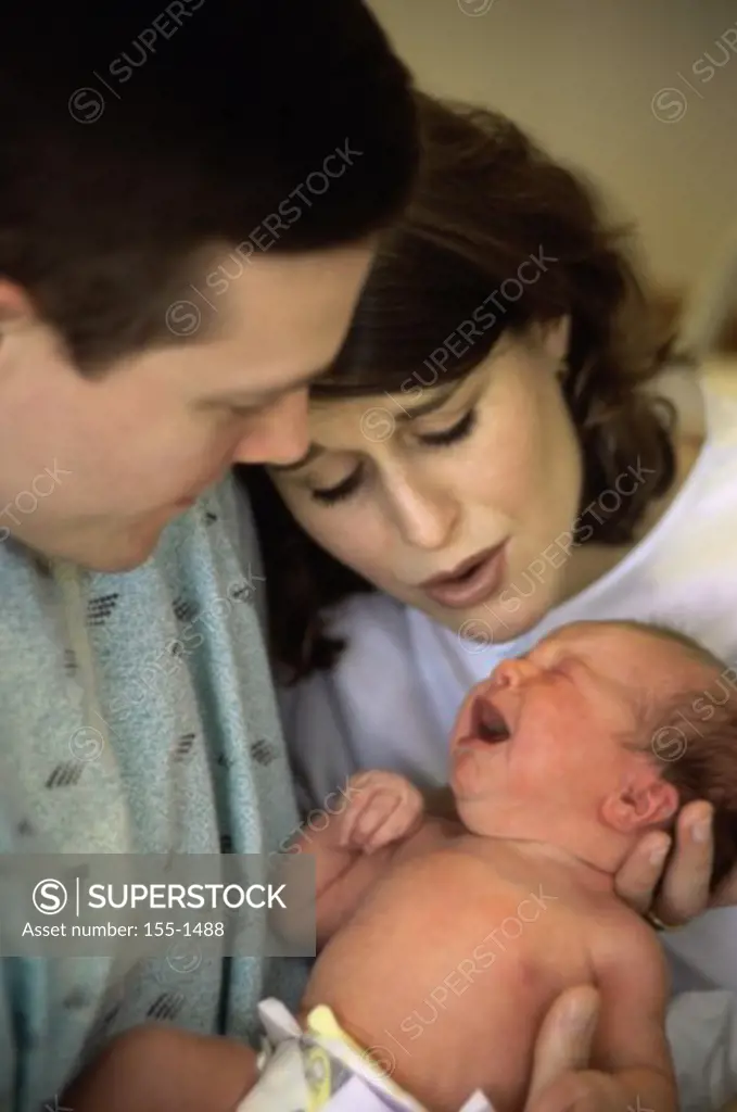 Young couple with their newborn baby