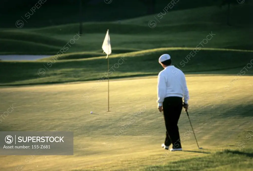 Rear view of a man standing on a golf course
