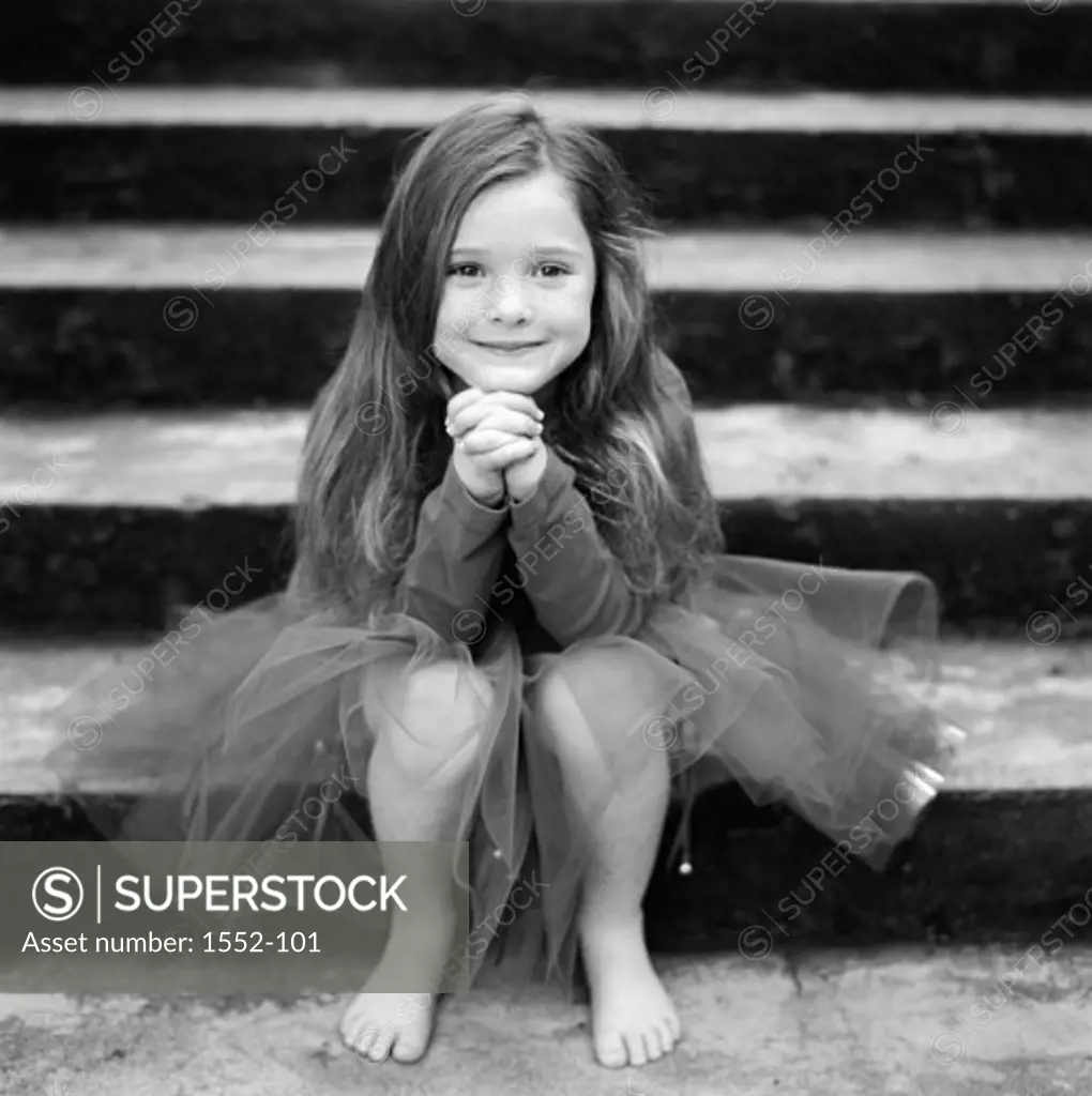Portrait of a girl sitting on steps and smiling