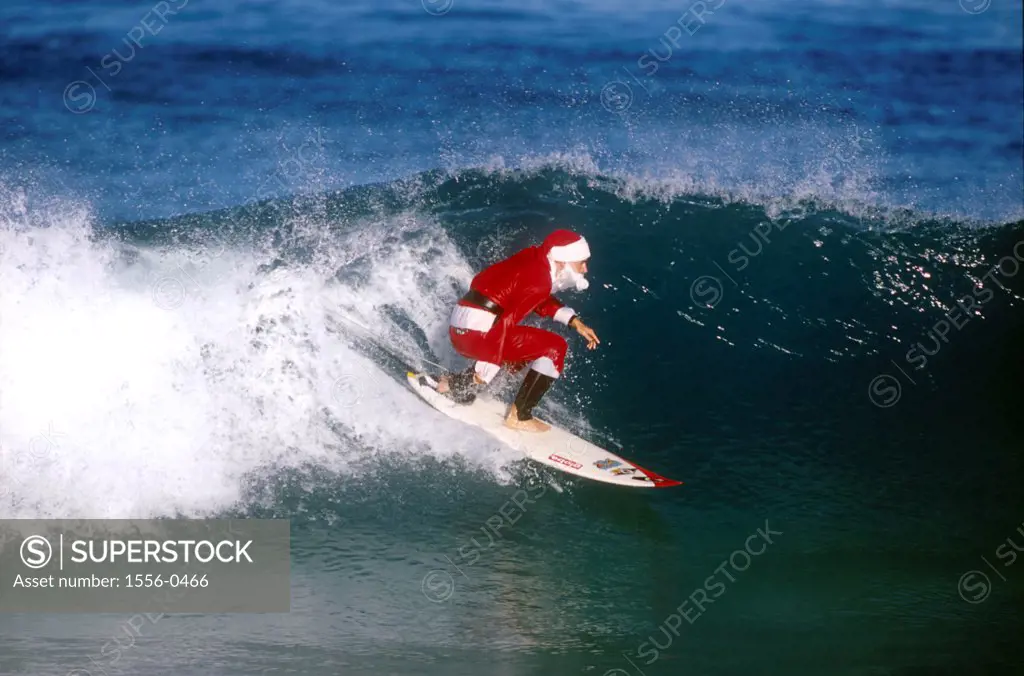 Santa Claus surfing