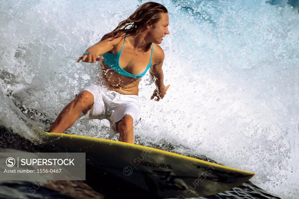 Young adult woman surfing, Tahiti