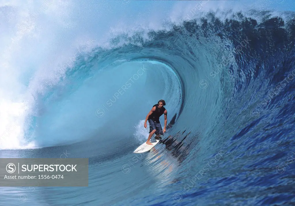 Young adult man surfing, Teahupoo, Tahiti