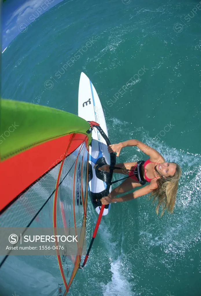 Young adult woman windsurfing, Maui, Hawaii, USA