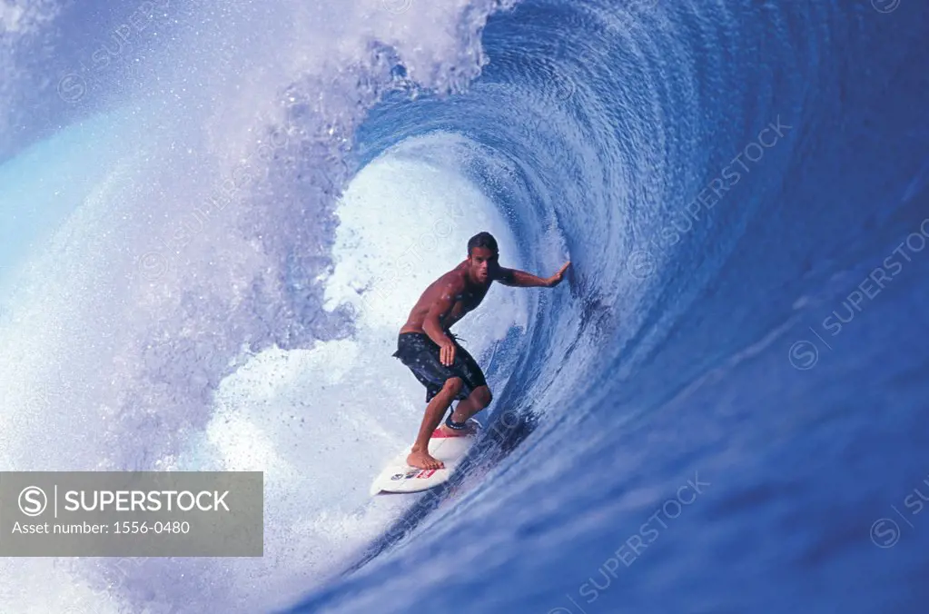 Young adult man surfing, Tahiti, French Polynesia