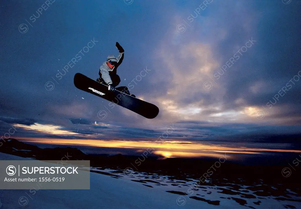 Person performing stunt on snowboard
