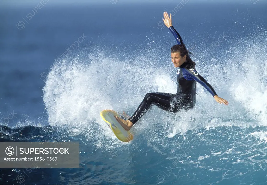 Young adult woman surfing