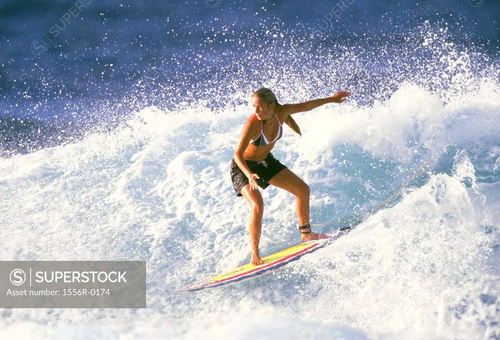 Young adult woman surfing, Hawaii, USA