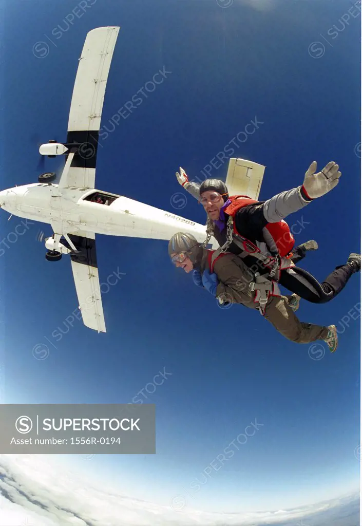 Two people skydiving (fish-eye lens)