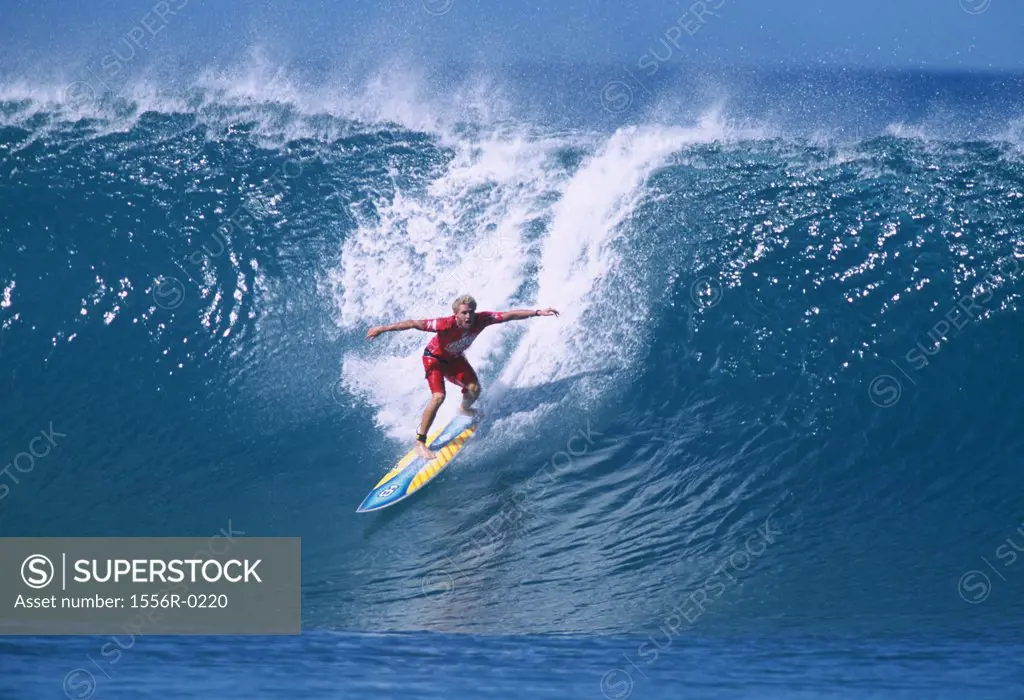 Young adult man surfing, Hawaii, USA