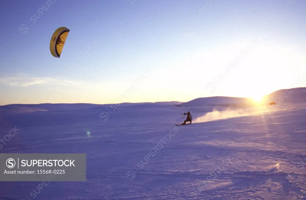 Kite skiing at sunset